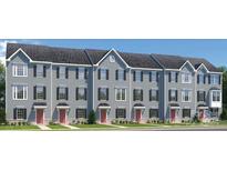 Exterior view of five attached townhouses with gray siding and red doors at 1805 Woodlands Pointe Dr, Charlotte, NC 28216