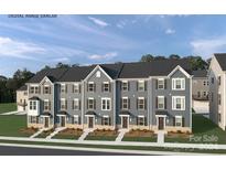 Row of new townhouses with gray siding, and front yards at 3006 Timber Mill Dr # 1001B, Stallings, NC 28104