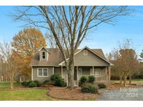 Gray house with front porch and landscaping at 3603 Twelve Mile Creek Rd, Weddington, NC 28104