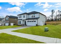 Two-story house with white siding, gray roof, and stone accents at 3050 Swallowtail Ln, Kannapolis, NC 28083