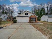 Brick front house with attached garage and landscaping at 7225 Preakness Stakes Ln, Charlotte, NC 28215