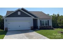 Newly constructed home with gray siding, two-car garage, and a landscaped lawn at 1550 Doran Ter, Richburg, SC 29729