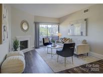 Bright living room features hardwood floors, a fireplace, and stylish furniture at 224 N Poplar St # 19, Charlotte, NC 28202