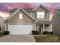 Two-story house with beige siding, white garage door, and landscaping at 2936 Westbury Ct, Dallas, NC 28034