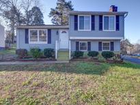 Two-story house with gray siding, landscaping, and a paved walkway at 7800 Highbanks Ct, Charlotte, NC 28212