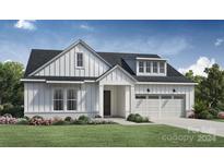 Charming farmhouse style home with white siding, landscaping, and two-car garage at 4107 Eastover Glen Rd # 0350, Charlotte, NC 28269