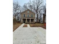 Two-story brick home with front porch and driveway at 4739 Whispering Oaks Dr, Charlotte, NC 28213