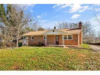 Brick ranch house with a covered porch and a spacious lawn at 3100 Nc Hwy 18 Hwy, Vale, NC 28168