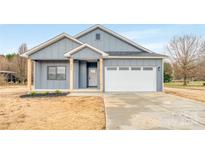 Newly constructed home with gray siding, white trim, and a two-car garage at 1856 County Line Rd, Kings Mountain, NC 28086