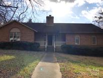 Brick ranch house with a front porch and walkway at 7221 Leaves Ln, Charlotte, NC 28213