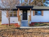Charming white house with a black door and wood accents at 138 Pounds Sw Ave, Concord, NC 28025