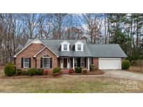 Brick ranch house with attached garage and landscaping at 2802 Tara Dr, Monroe, NC 28112