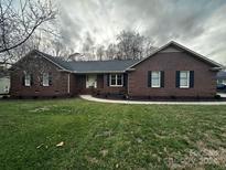 Brick ranch house with landscaped lawn and walkway at 4227 Inwood Dr, Rock Hill, SC 29732