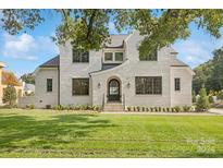 Two-story brick home with a landscaped lawn and a welcoming front entrance at 669 Dogwood Ln, Davidson, NC 28036