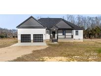 Two-story home with gray roof and two-car garage at 7510 Water Oak Ln, Monroe, NC 28110