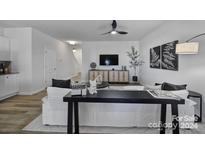 Bright living room features a comfy white sofa, modern console table, and stylish decor at 208 Briana Marie Way, Indian Trail, NC 28079