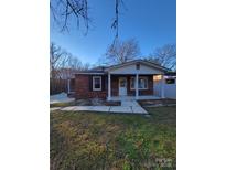 Brick ranch house with a covered porch and landscaped yard at 111 Dye St, Chester, SC 29706