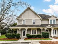 Tan two-story house with front porch and landscaping at 2725 Von Thuringer Ct, Charlotte, NC 28210