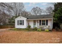 Charming white house with a covered porch, landscaping, and a spacious yard at 333 W Wilson Ave, Mooresville, NC 28115