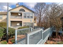 Exterior view of condo building with walkway and landscaping at 8121 #E Tremaine Ct, Charlotte, NC 28227