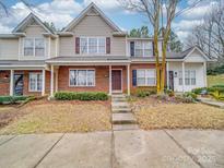 Brick front townhouse with steps leading to the entrance and a small yard at 16967 Turning Stick Ct, Charlotte, NC 28213