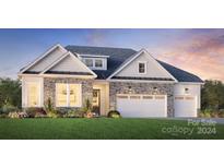 Craftsman style home with stone accents and a two-car garage at 5365 Mint Harbor Way # 0300, Charlotte, NC 28269