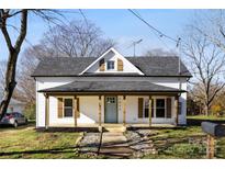 Charming white farmhouse with a covered porch and landscaped walkway at 1024 8Th St, Statesville, NC 28677