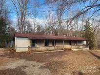 Ranch style home with a covered porch and wooded lot at 4766 Dolph Monroe Rd, Maiden, NC 28650