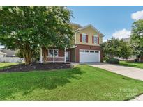 Two-story house with brick and siding, attached garage, and landscaping at 1003 Blue Range Rd, Indian Trail, NC 28079