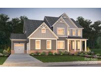 Two-story home with gray siding, a covered porch, and a two-car garage at 14110 White Gardens Ln # 23, Huntersville, NC 28078