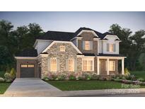Two-story brick home with stone accents, shutters, and a two-car garage at 14126 White Gardens Ln # 22, Huntersville, NC 28078