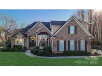 Brick home with landscaping and a large front yard at 1740 Withers Dr, Denver, NC 28037