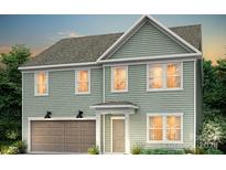 Two-story house with light green siding, brown garage door, and a covered entryway at 5219 Hatcher Creek Rd # 041, Charlotte, NC 28215