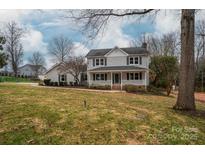 Two-story house with gray siding, white trim, and a spacious yard at 640 Deerfield Dr, Mount Holly, NC 28120