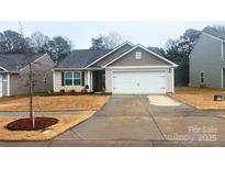 Charming house with a two-car garage and well-maintained lawn at 1401 Nia Rd, Charlotte, NC 28215