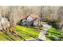 Aerial view of a two-story house with a large backyard and driveway at 3613 Savannah Way, Monroe, NC 28110