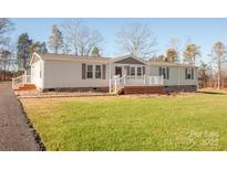 Ranch style home with landscaping and driveway at 816 Perry Rd, Troutman, NC 28166