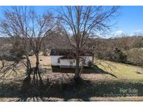 Aerial view of a charming house with large yard and trees at 315 Old Mill Rd, Shelby, NC 28150