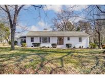 Charming ranch home with brick facade and landscaped lawn at 129 N Magnolia St, Mooresville, NC 28115