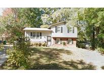 Two-story house with brick and white siding, shutters, and a front yard at 5139 Springview Rd, Charlotte, NC 28213