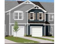 Two-story townhome with gray and blue siding, two-car garage, and landscaping at 7224 Hodges Meadow Ln, Charlotte, NC 28213