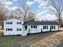 White brick ranch house with black trim, steps, and landscaping at 155 Mcadam Ln, Mooresville, NC 28117