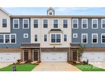 Three-unit townhome building, two-car garages, neutral gray and brick exterior, and landscaping at 4339 Reed Creek Dr, Sherrills Ford, NC 28673