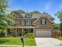 Two-story brick home with a large front yard and attached garage at 4624 Pebble Run Dr, Matthews, NC 28105