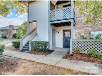 Inviting condo exterior with private entrance and steps leading to the front door at 5847 Harris Grove Ln, Charlotte, NC 28212