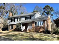 Brick house with gray siding, white trim, and a spacious yard at 1364 5Th Street Nw Cir, Hickory, NC 28601