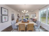 Bright dining room features a table with four chairs, hardwood floors, and natural light at 4360 Bronze Blvd, Sherrills Ford, NC 28673