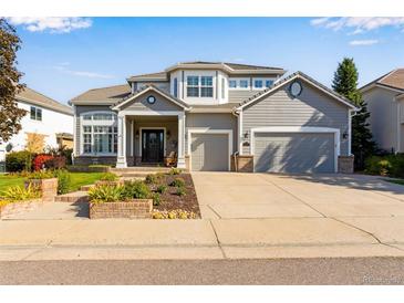 Two-story home with three car garage and landscaped yard at 10364 Carriage Club Dr, Lone Tree, CO 80124