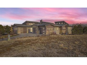 Stunning contemporary home with three-car garage and expansive windows at 11364 Birolli Pl, Littleton, CO 80125