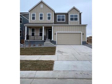 Two-story house with neutral siding, a large garage, and a small porch at 5621 W 141St Ln, Broomfield, CO 80020